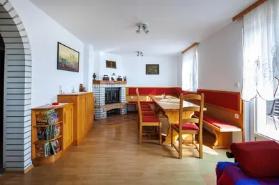 a dining room with a table and a fireplace at Vineyard cottage Cvitkovič in Adlešiči