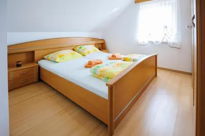 a bedroom with a bed with two pillows at Vineyard cottage Cvitkovič in Adlešiči