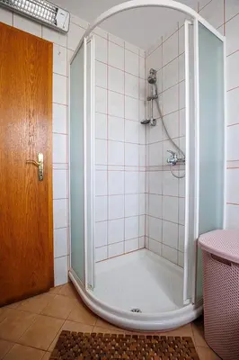 a shower with a glass door in a bathroom at Vineyard cottage Cvitkovič in Adlešiči