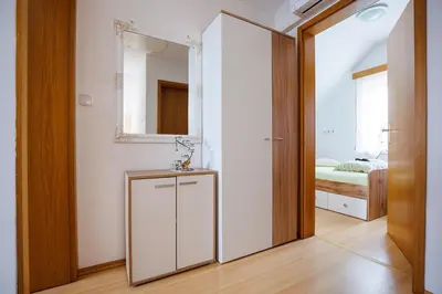 a bathroom with a mirror and a sink in a room at Vineyard cottage Cvitkovič in Adlešiči