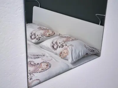 a white bed with three pillows on it at Apartmaji Jakob 1 in Bovec