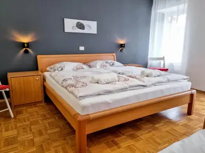 a bedroom with a large bed with a wooden frame at Apartmaji Jakob 1 in Bovec