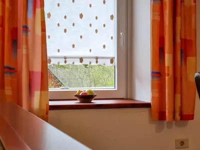 a window with a bowl of fruit on a window sill at Apartmaji Jakob 1 in Bovec