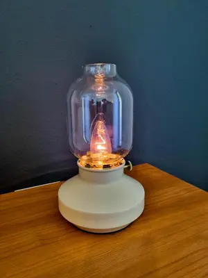a glass jar with a light in it on a table at Apartmaji Jakob 1 in Bovec