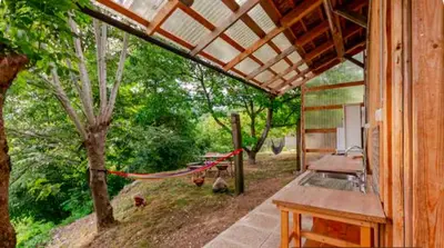 a porch of a house with a hammock on it at Beehive cabin on a farm in Radovljica