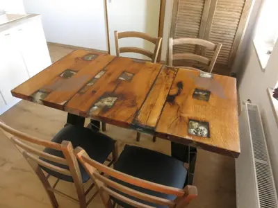 a wooden table with chairs around it in a kitchen at Turistična kmetija Izgoršek in Griže