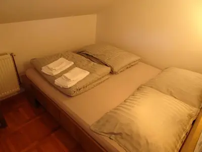 two beds in a small room with towels on them at Turistična kmetija Izgoršek in Griže