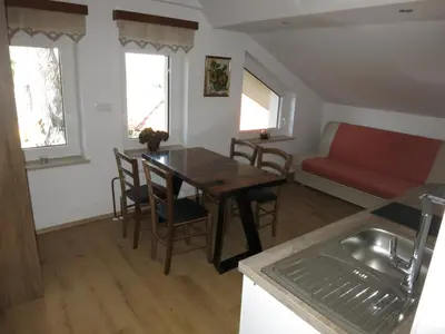 a kitchen and dining room with a table and a couch at Turistična kmetija Izgoršek in Griže