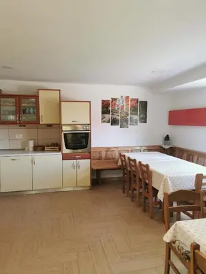 a kitchen and dining room with a table and chairs at APARTMA BREST in Gornji Grad