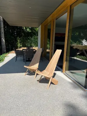 two wooden chairs and a table on a patio at Ambient Resort Bled in Bled