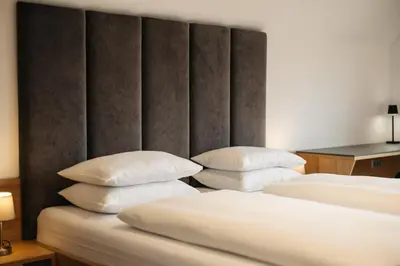 two beds with white pillows in a room at Ambient Resort Bled in Bled
