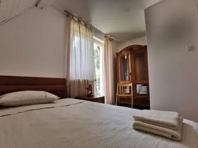 a bedroom with a bed with towels on it at Sanjska Hiša Vojsko in Idrija