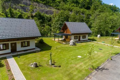 an aerial view of a house with a yard at Resort Stari Malni, Osilnica - vacation houses Stari Malni in Osilnica