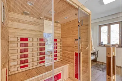 a bathroom with a shower with wooden walls at Resort Stari Malni, Osilnica - vacation houses Stari Malni in Osilnica