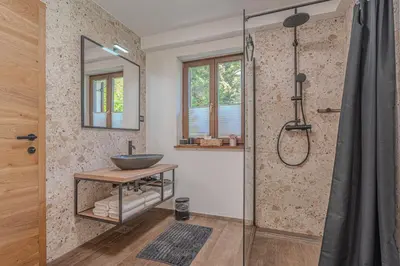 a bathroom with a sink and a glass shower at Resort Stari Malni, Osilnica - vacation houses Stari Malni in Osilnica
