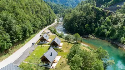 an aerial view of a house next to a river at Resort Stari Malni, Osilnica - vacation houses Stari Malni in Osilnica