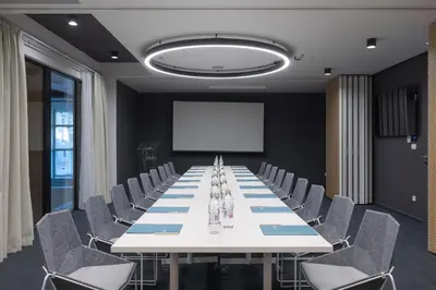 a conference room with a long table and chairs at Occidental Ljubljana in Ljubljana