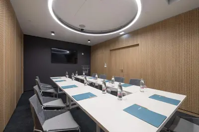 a conference room with a long table and chairs at Occidental Ljubljana in Ljubljana