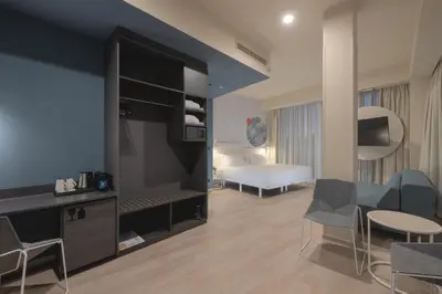 a living room with a room with a bedroom at Occidental Ljubljana in Ljubljana