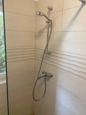 a shower with a shower head in a bathroom at Apartma Magnolija in Nova Gorica