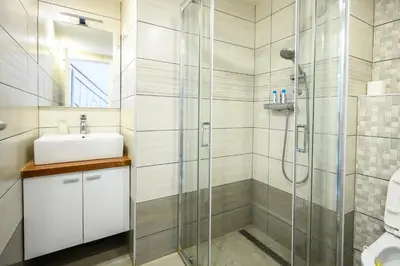 a bathroom with a shower and a sink at The Happy Loft in Ljubljana