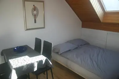 a small bedroom with a bed and a table at Savinja River Residence in Ljubno