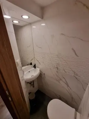 a white bathroom with a sink and a toilet at Savinja River Residence in Ljubno