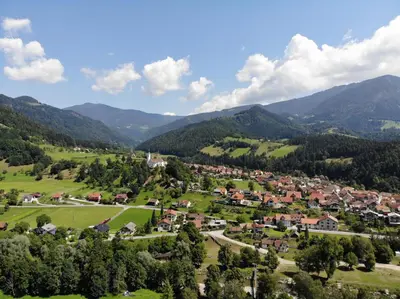 an aerial view of a village in the mountains at Savinja River Residence in Ljubno