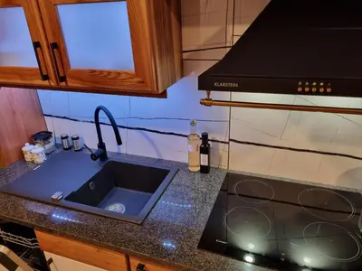 a kitchen with a sink and a stove at Savinja River Residence in Ljubno