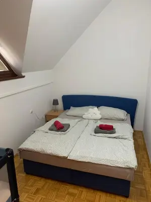a bedroom with a bed with two pillows on it at Lotty in Čatež ob Savi