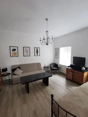 a living room with a couch and a tv at Belavita in Bovec