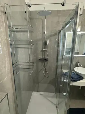a glass shower in a bathroom with a sink at Belavita in Bovec