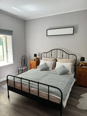 a bedroom with a bed with a metal frame and pillows at Belavita in Bovec