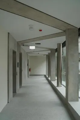 an empty hallway of an office building with columns at Castle View Luxury Suite in Ljubljana