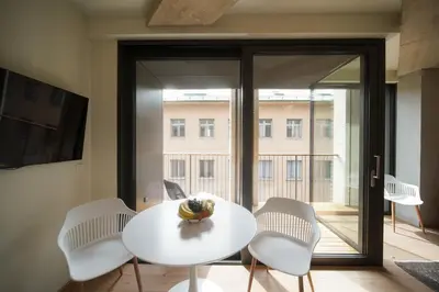 a white table and chairs in a room with a window at Castle View Luxury Suite in Ljubljana