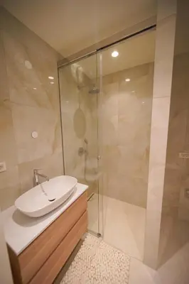 a bathroom with a sink and a shower at Castle View Luxury Suite in Ljubljana
