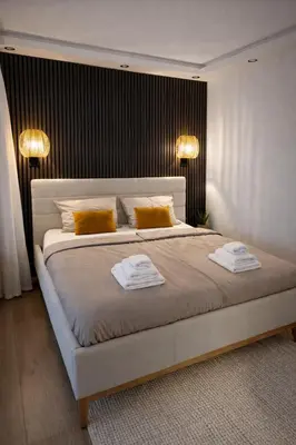 a bedroom with a large bed with two towels on it at Keleia Nova Vas Design Apartment Celje in Celje
