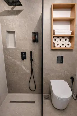 a bathroom with a toilet and a shower at Keleia Nova Vas Design Apartment Celje in Celje