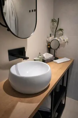 a bathroom with a large white sink on a counter at Keleia Nova Vas Design Apartment Celje in Celje