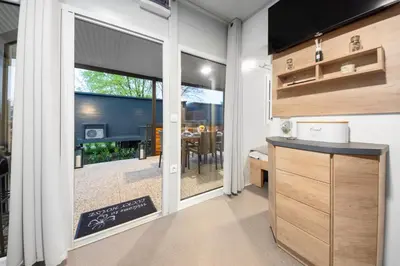 a kitchen with a sliding glass door leading to a dining room at Glamping Lucky House in Gradac