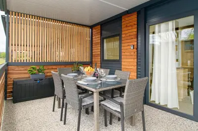 a dining table and chairs on a patio at Glamping Lucky House in Gradac