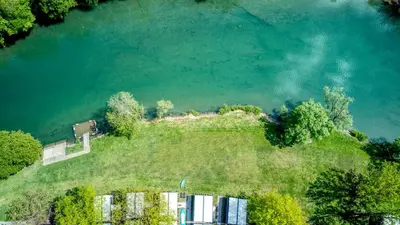 an aerial view of an island in the middle of a lake at Glamping Lucky House in Gradac
