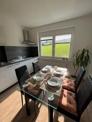 a dining room with a table and chairs in a kitchen at Apartment Dalija - Cosy Apartment & Rooms with Massage Studio in Podčetrtek