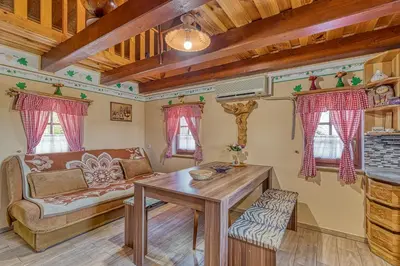 a living room with a couch and a table at Vineyard Cottage Vesna Lake View - Happy Rentals in Veliki Vrh