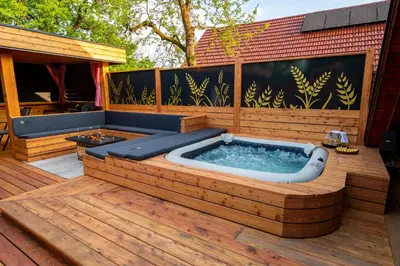 a hot tub sitting on a wooden deck at House 