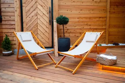 two folding chairs sitting on a deck at House 