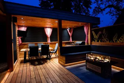 a patio with a table and chairs on a deck at House 