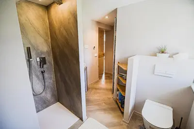a bathroom with a shower and a toilet at Mountain View Apartment with Sauna in Cerklje na Gorenjskem