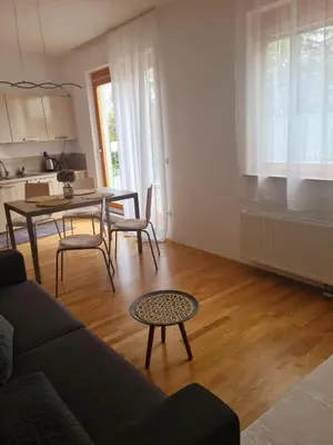 a living room with a couch and a table at Pohorske terase Gabi in Pohorje