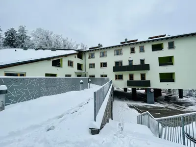 a building with snow in front of it at Pohorske terase Gabi in Pohorje